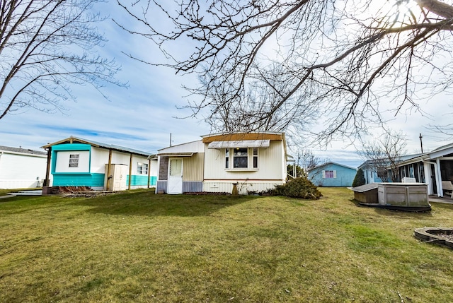 rear view of property with a lawn