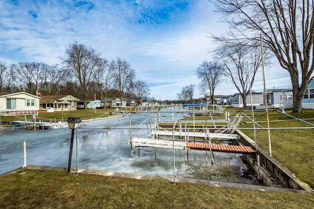 dock area with a residential view and a yard