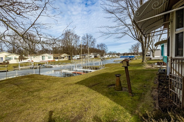 view of yard with a boat dock and a residential view