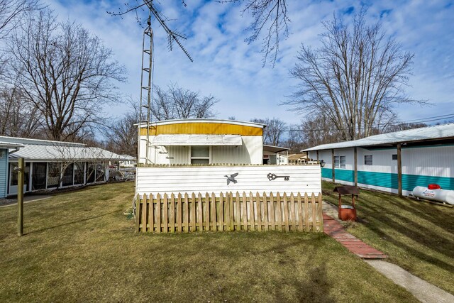 rear view of property with a lawn