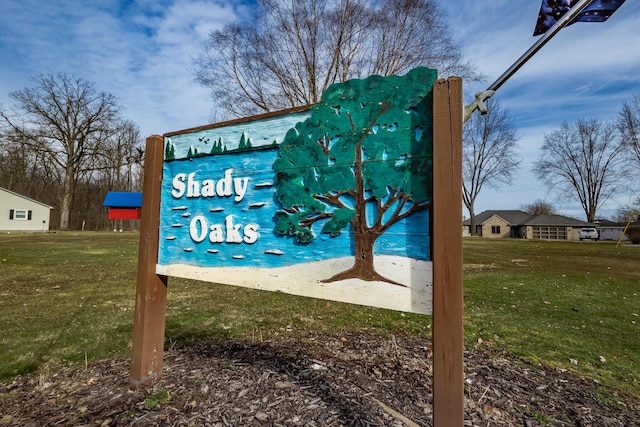 community sign featuring a lawn