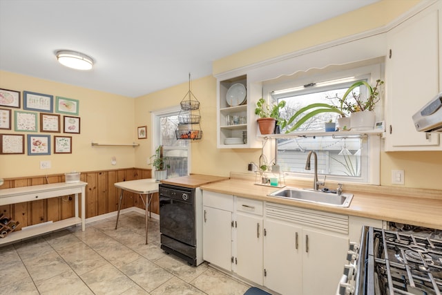 kitchen with white cabinets, dishwasher, light countertops, pendant lighting, and a sink