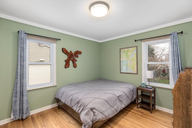 bedroom with wood finished floors and baseboards