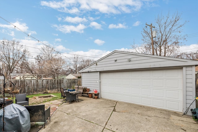 detached garage featuring fence