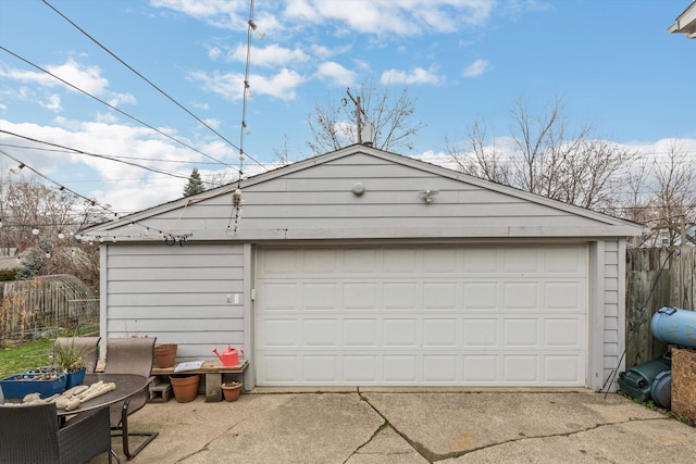 detached garage featuring fence