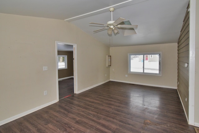 unfurnished room featuring dark wood-style floors, ceiling fan, baseboards, and vaulted ceiling