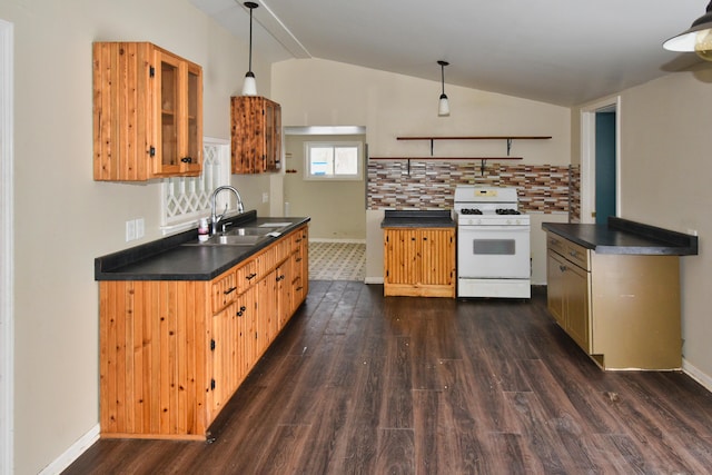 kitchen with dark wood finished floors, gas range gas stove, lofted ceiling, dark countertops, and a sink