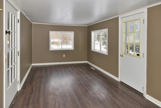 foyer with dark wood-style floors, baseboards, and ornamental molding