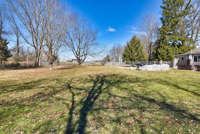 view of yard featuring fence and a wooden deck