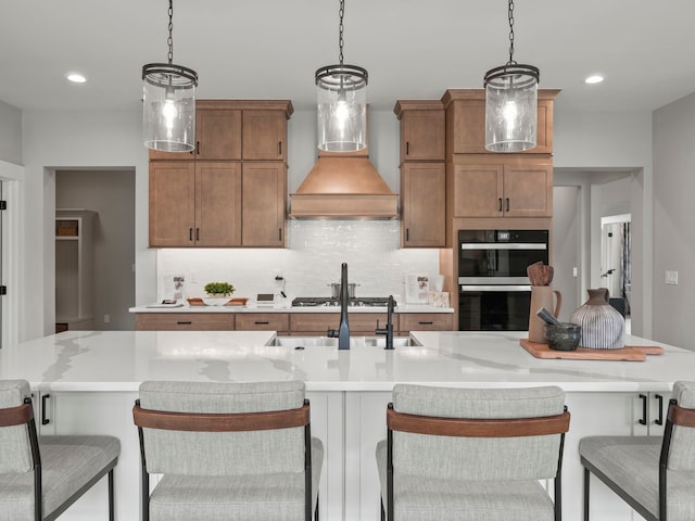 kitchen with light countertops, appliances with stainless steel finishes, custom exhaust hood, and backsplash