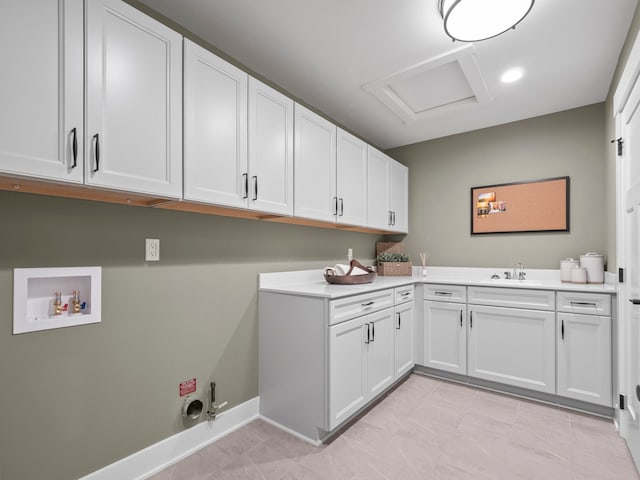 clothes washing area featuring cabinet space, attic access, hookup for a gas dryer, washer hookup, and a sink