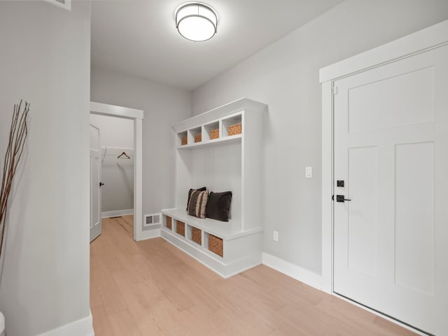 mudroom with light wood-style flooring, visible vents, and baseboards