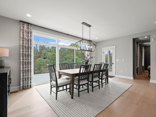 dining area featuring a notable chandelier, light wood finished floors, recessed lighting, and baseboards