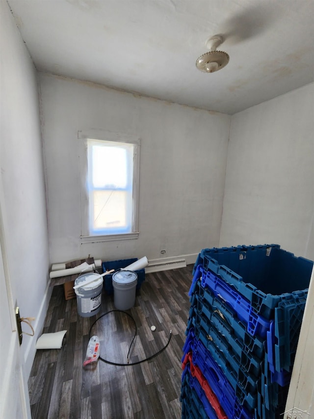 bedroom featuring baseboards and wood finished floors