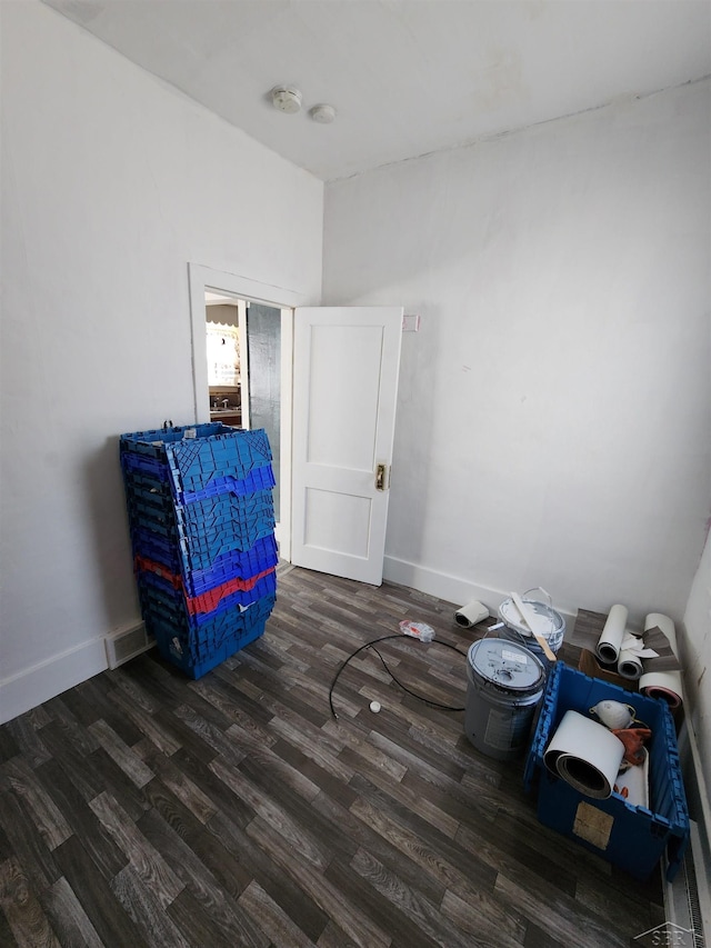 bedroom with visible vents, baseboards, and wood finished floors