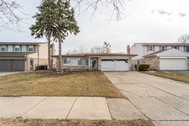 traditional home with a front yard, concrete driveway, a chimney, and an attached garage