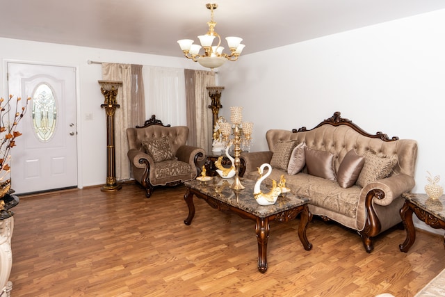 living room with an inviting chandelier and wood finished floors