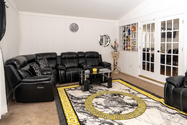 living room featuring vaulted ceiling, carpet floors, and french doors