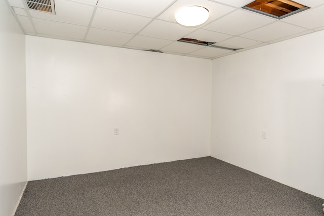 carpeted empty room featuring a drop ceiling and visible vents