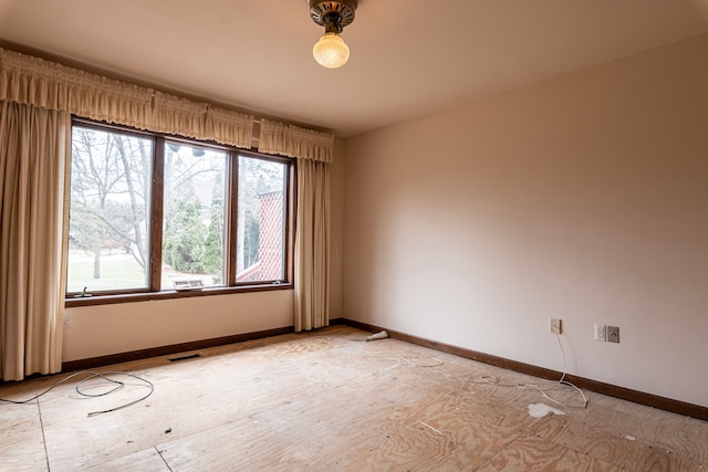 spare room featuring visible vents and baseboards