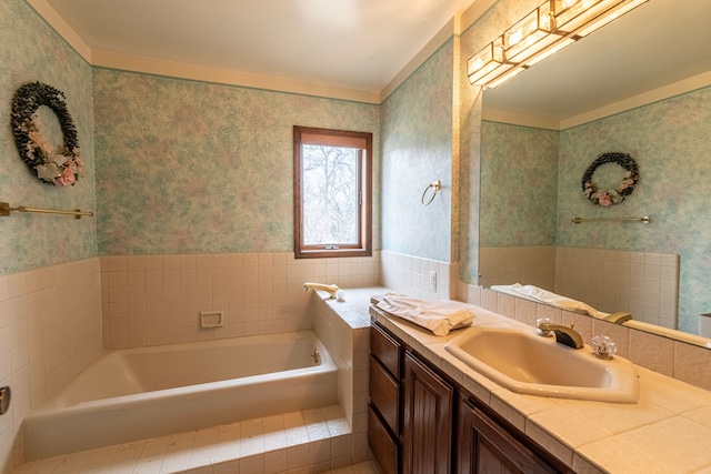 bathroom featuring wallpapered walls, a bath, and vanity