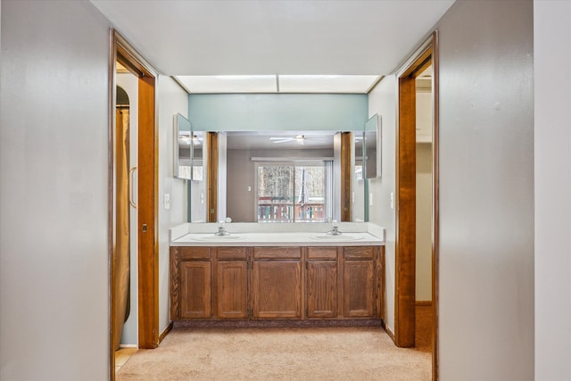 bathroom with double vanity, a sink, and a ceiling fan