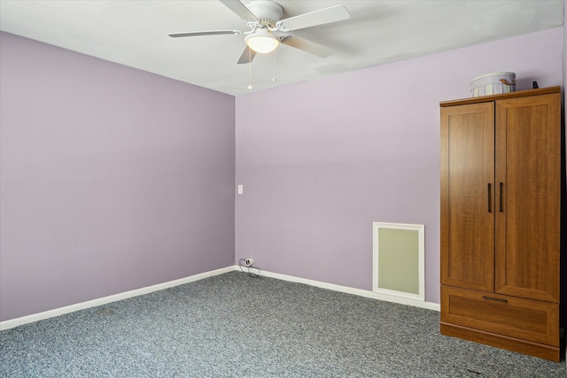 spare room with carpet floors, baseboards, and a ceiling fan