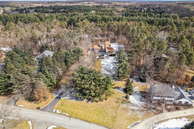 bird's eye view with a wooded view