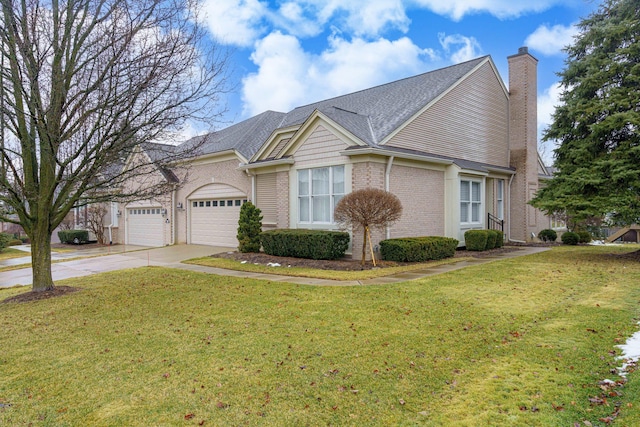 view of front of home with concrete driveway, a front lawn, a chimney, and brick siding