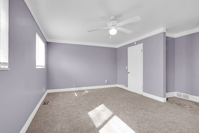 carpeted empty room featuring visible vents, baseboards, and ceiling fan