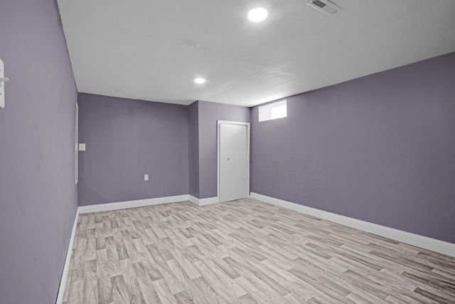 basement featuring recessed lighting, wood finished floors, visible vents, and baseboards