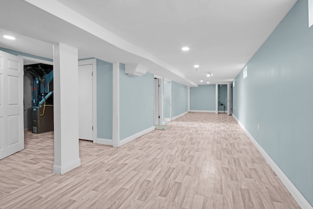 finished basement with light wood-style flooring, recessed lighting, and baseboards