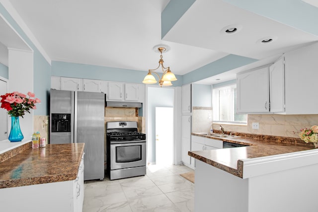 kitchen with under cabinet range hood, white cabinets, dark countertops, and appliances with stainless steel finishes