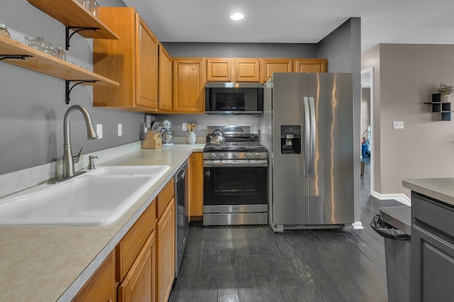 kitchen with dark wood-style flooring, open shelves, light countertops, appliances with stainless steel finishes, and a sink