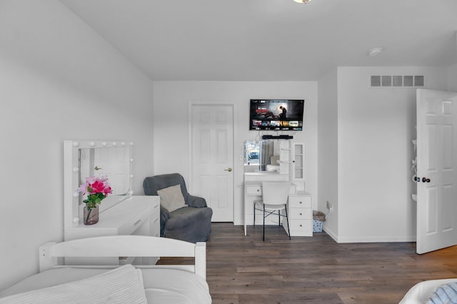 bedroom with dark wood-type flooring, visible vents, and baseboards