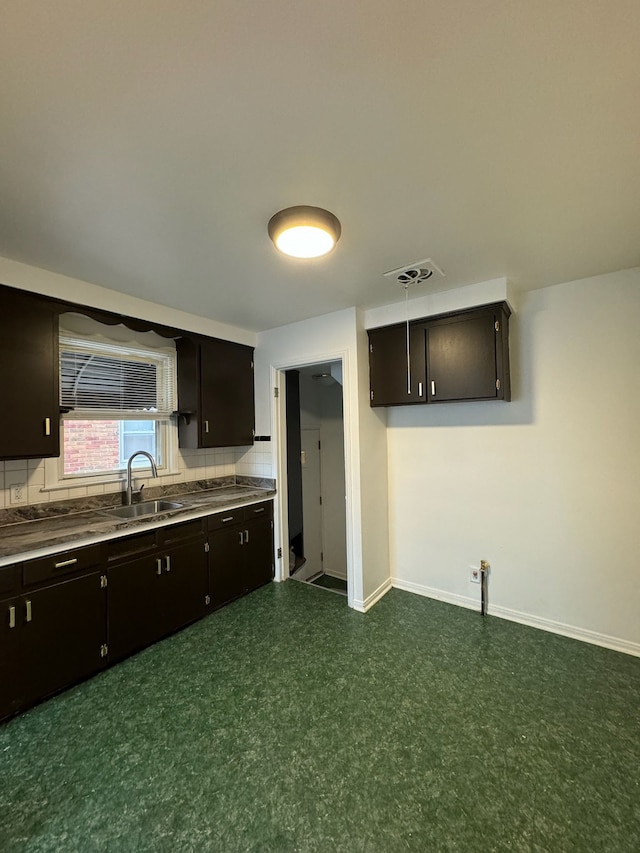 14919 Fairmount Dr, Detroit, MI 48205 - kitchen with tasteful backsplash, baseboards, visible vents, dark floors, and a sink