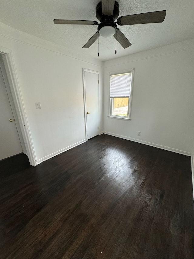 14919 Fairmount Dr, Detroit, MI 48205 - interior space with a ceiling fan, a textured ceiling, baseboards, and dark wood-type flooring