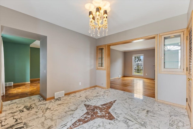 unfurnished room featuring marble finish floor, visible vents, and baseboards