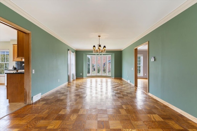 empty room featuring a chandelier, visible vents, and baseboards