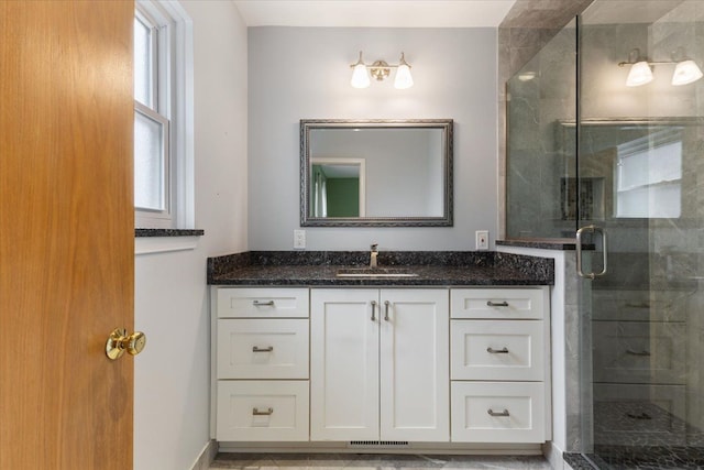 bathroom with visible vents, a stall shower, and vanity