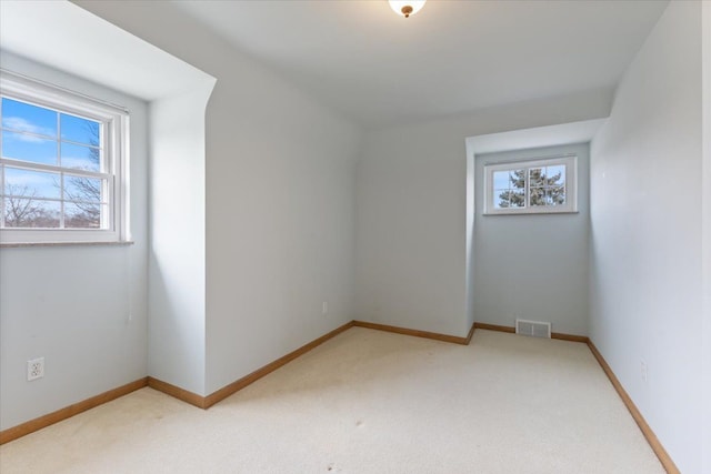 bonus room with baseboards, visible vents, and light colored carpet