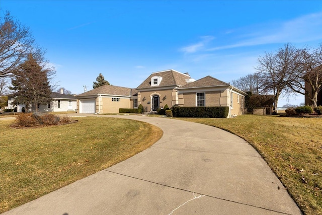 view of front of house with concrete driveway and a front lawn