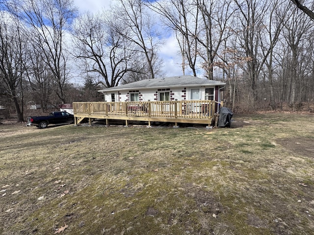 view of front of house with a deck and a front yard