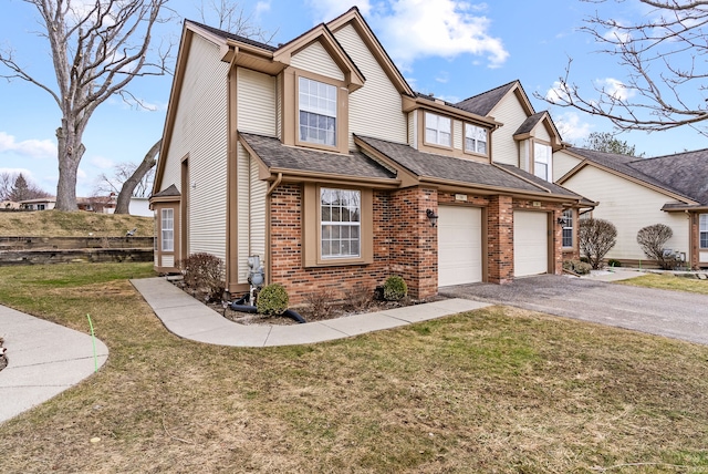 view of front of home with a garage, a front yard, aphalt driveway, and brick siding