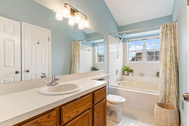 full bathroom featuring tile patterned flooring, tiled shower / bath, toilet, and vanity