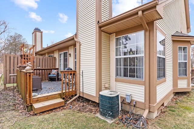 wooden terrace with fence and central air condition unit