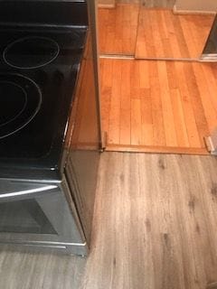 30200 Southfield Rd Unit 204, Southfield, MI 48076 - detailed view of wood finished floors and stove