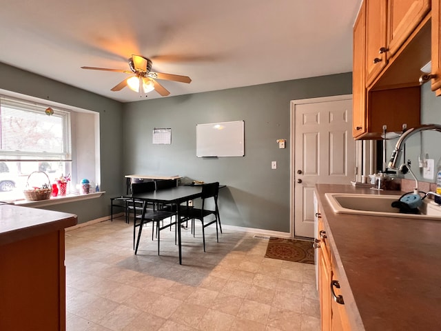 dining area featuring ceiling fan and baseboards