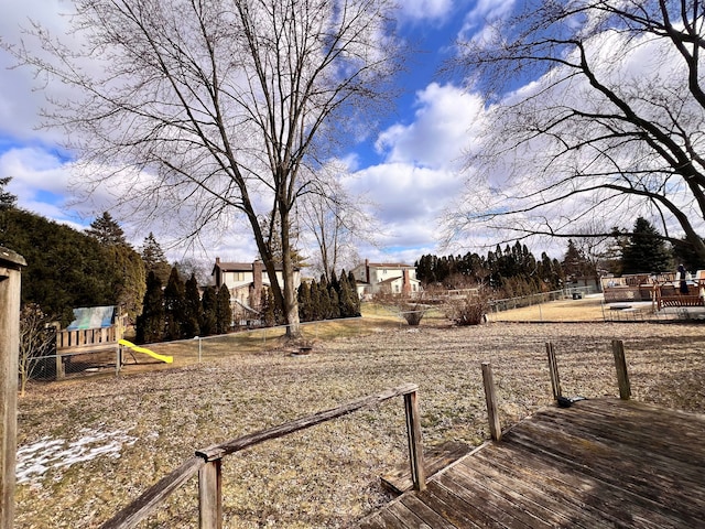 view of yard featuring playground community and a deck