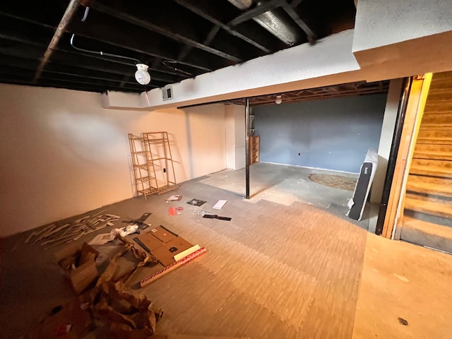 finished basement with visible vents and stairway